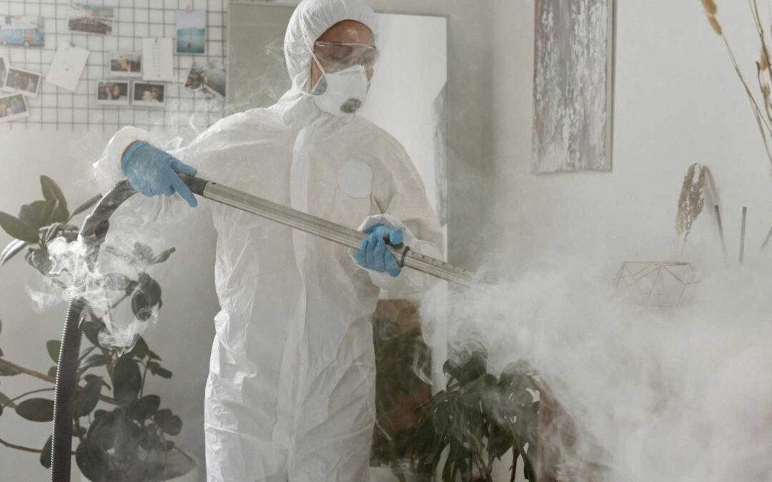 washroom steam cleaning technician using a steam wand in a protective suit